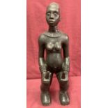 A bronze figurine of a tribal figure.