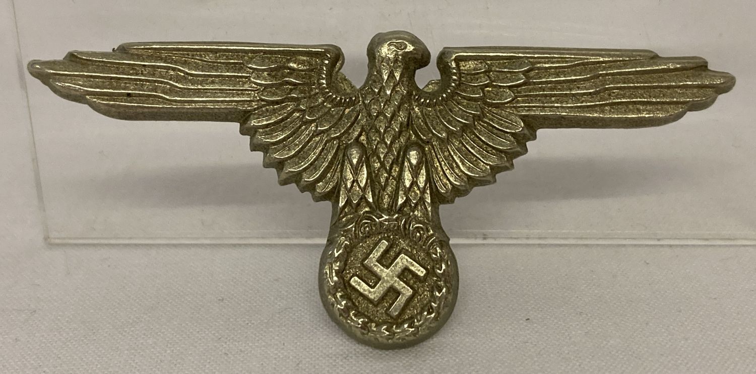 A WWII style German NCO eagle design cap badge.