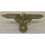A WWII style German NCO eagle design cap badge.