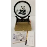 A boxed Chinese Shu embroidered silk rotating panel on decorative wooden stand.