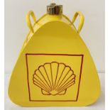 A decorative triangular shaped shell fuel can with brass screw cap.
