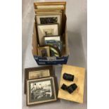 A box of mixed items To include pictures, books and camera lenses.