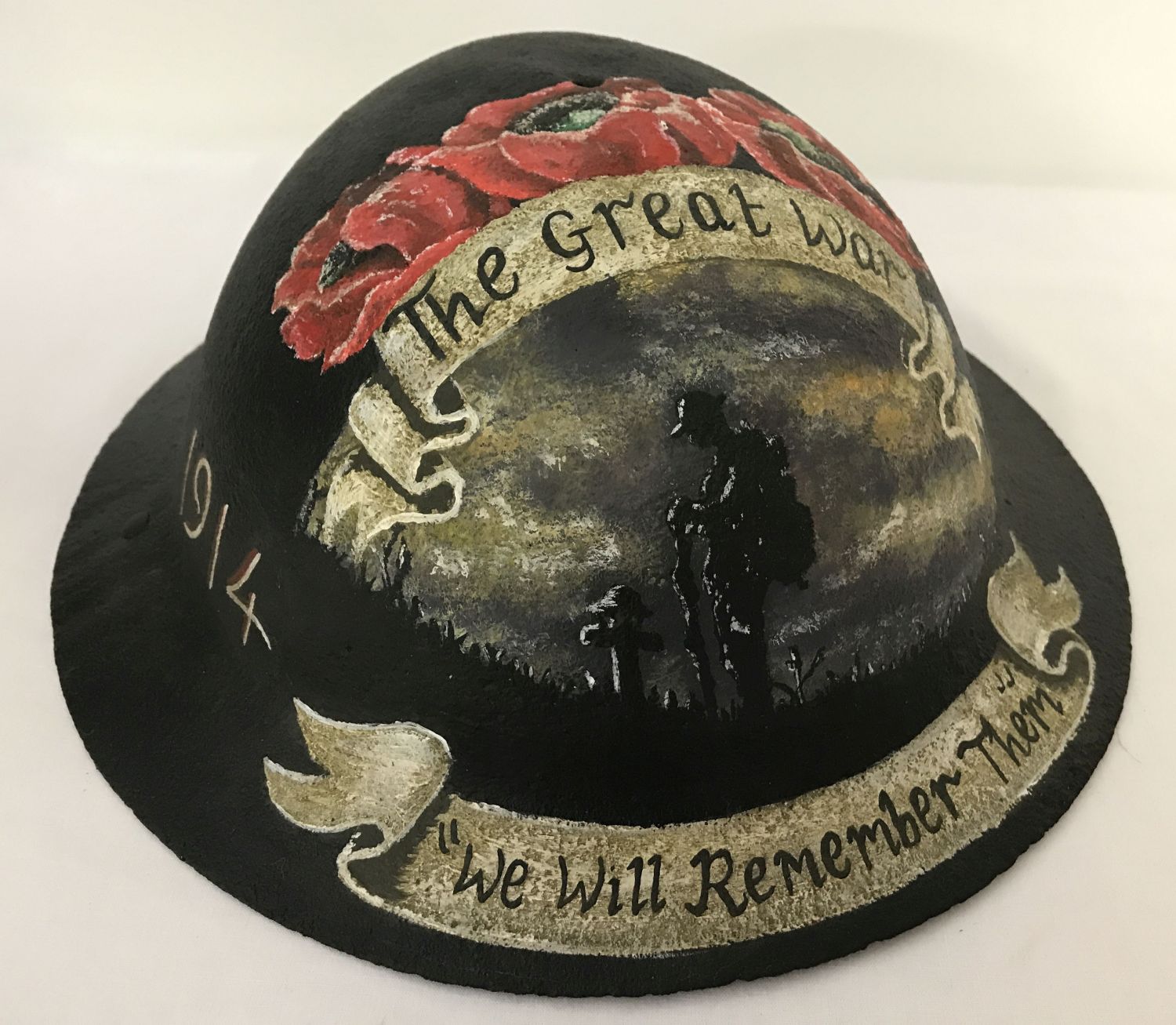 A British WWI style Brodie helmet with post war memorial hand painted detail.