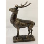 A bronzed effect cat metal figure of a stag.