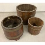 A vintage brass banded Coopered barrel plant pot holder on 3 feet by R.A Lister & Co, Ltd.