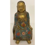 A hollow brass figure of an Oriental Deity with cloisonné detail to robes.