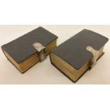 2 antique leather bound bibles with decorative silver clasps.