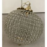 A heavily beaded spherical shaped Empire style lamp shade with brass detail.