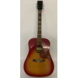 A vintage Laramie acoustic guitar with hummingbird decoration to pick guard and red finish to body.