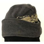 A German WWII style Luftshutz (Air Raid Police) side cap with embroidered badge.