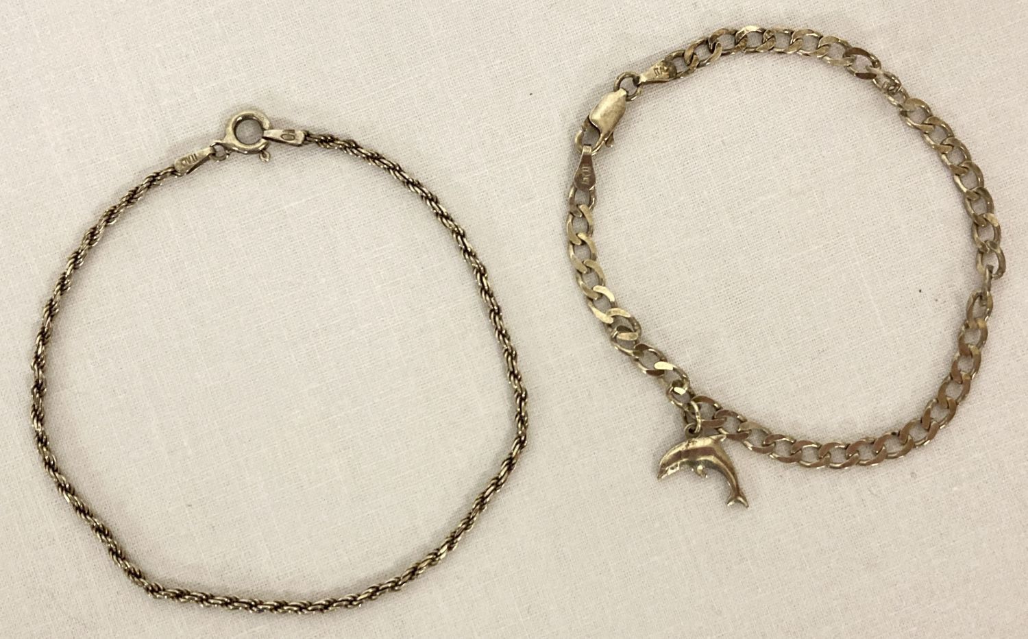 2 silver bracelets. A rope chain bracelet with spring clasp.