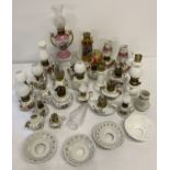 A quantity of vintage ceramic miniature oil lamp figurines.