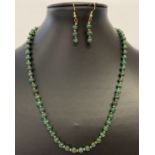 A 19" malachite beaded necklace and matching earrings.