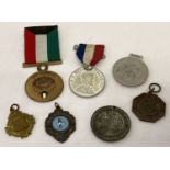 A collection of medals, medallions and fobs.