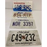 A collection of plastic and aluminium American display license plates.