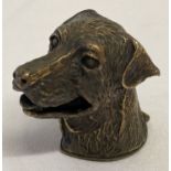 A brass vesta case in the shape of a dogs head.