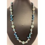 A 23" beaded necklace with fresh water peacock pearls, aquamarine coloured agate & white metal beads