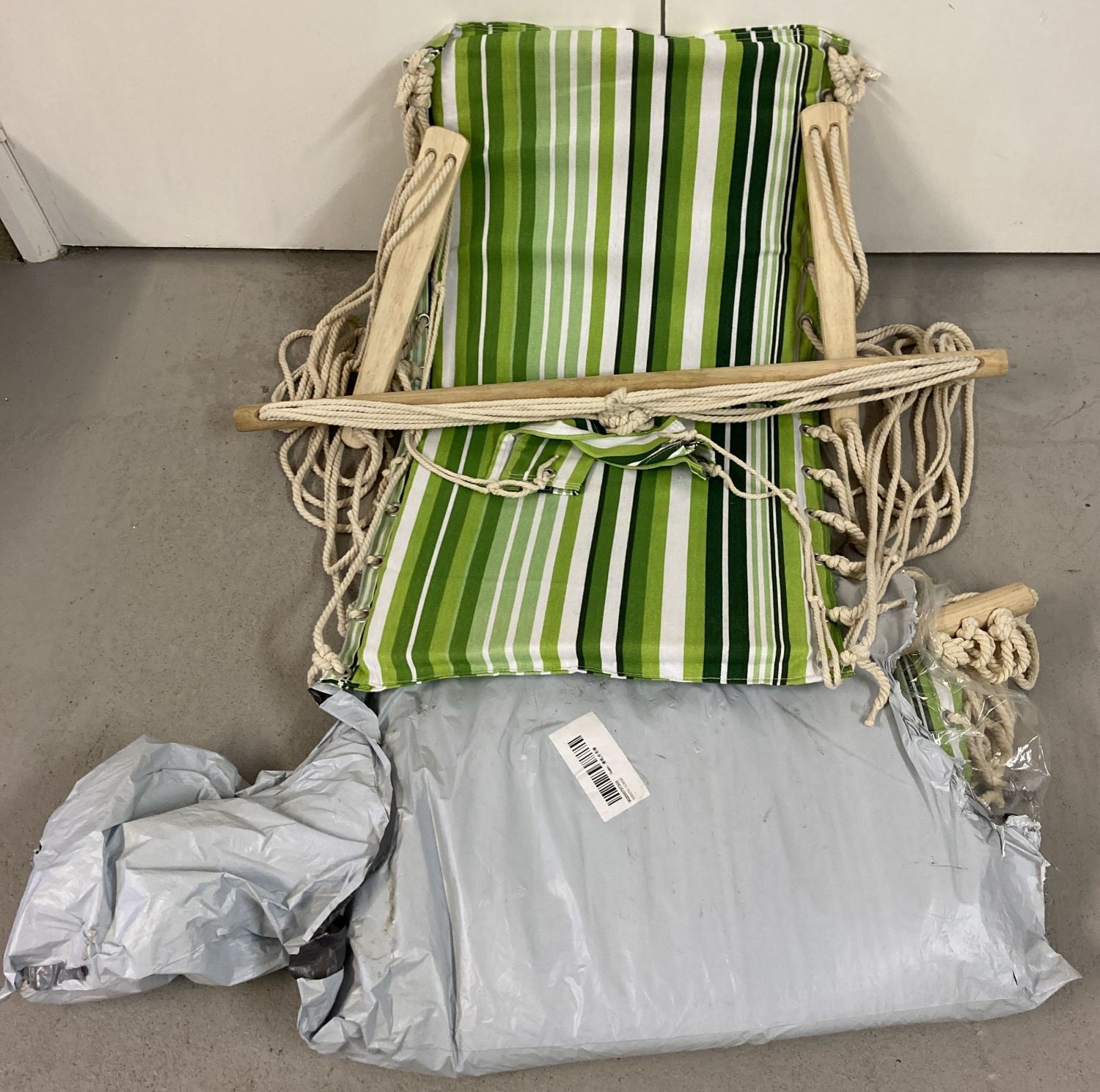 A pair of garden hanging hammock seats with green stripe decoration.