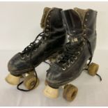 A pair of vintage leather roller skates.
