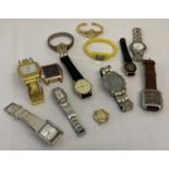 A box of ladies and men's modern wristwatches in varying styles and conditions.