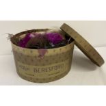 A Hugh Beresford Ltd vintage hat box containing a quantity of coloured feathers for hats and dress