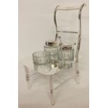 A silver plated and cut glass novelty cruet in the shape of a chair.