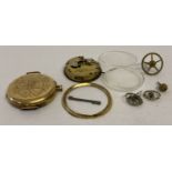 An antique 18ct gold pocket watch case with watch parts.