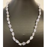A 20" Chalcedony beaded necklace with decorative white metal T bar clasp and spacer beads.