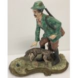 A large Capodimonte ceramic figure of a hunter and his dog a/f.