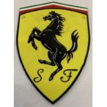 A painted cast iron Ferrari wall hanging plaque.