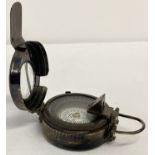 A reproduction metal cased military compass.