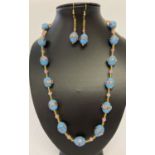 A 24" pale blue Venetian glass beaded necklace with matching earrings.