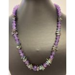 A 20" amethyst and peacock keshi pearl necklace, with white metal S shaped clasp.