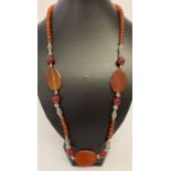 A 26" carnelian and white metal beaded necklace with T bar clasp.