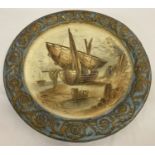 A large vintage ceramic wall plaque. Central boat design with gilt detailing.