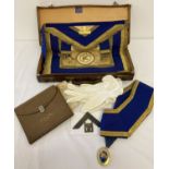 A vintage Masonic cowhide case containing a quantity of Provisional Regalia.