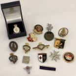 A collection of vintage and modern enamelled pin badges.