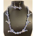 A 19" blue and white hand painted ceramic beaded necklace and matching earrings.