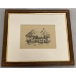 A framed and glazed pencil and chalk drawing of a rural cottage signed to bottom left M.Preston.
