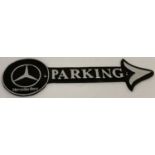 A painted cast iron wall hanging Mercedes parking arrow, in black and silver.