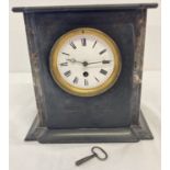 An antique black slate and marble mantle clock complete with key and pendulum.