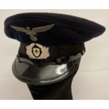 A 1950's German WWII Veterans peaked cap with wartime Veterans cap badge.