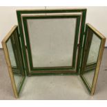A triple folding dressing table mirror with green and gilt frame.