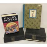 A first edition of Harry Potter and the Deathly Hallows without dust cover, damage to one corner.