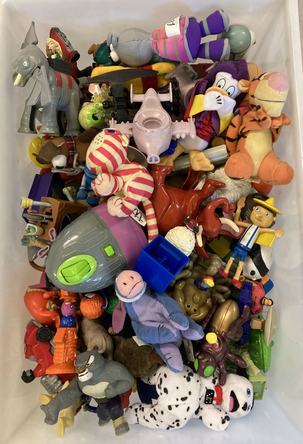 A large quantity of unsealed play worn McDonalds Happy Meal toys.