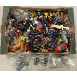 A box of assorted action figures, vehicles and weapons.