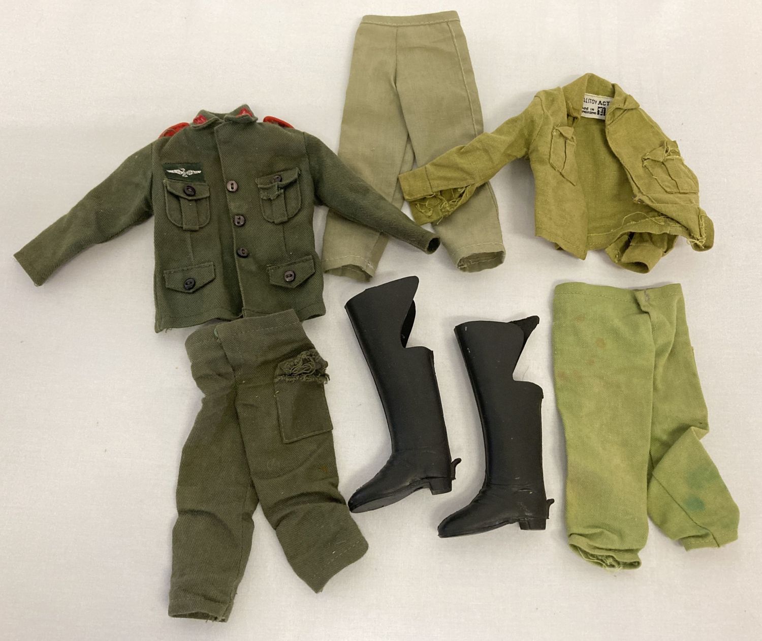 A small collection of vintage Palitoy Action Man military uniform.