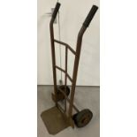 A vintage metal sack barrow with rubber tyres and grip handles.