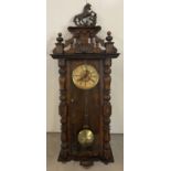 An antique dark wood cased Vienna style wall clock with glass panelled case.