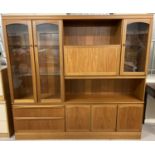 A large retro teak wood wall unit by McIntosh.